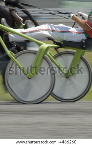closeup of wheels of sulky showing action and blur