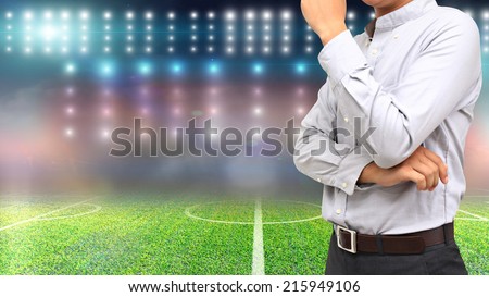 Football manager with soccer field and bright spotlights.