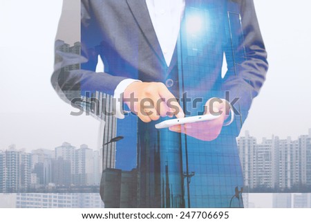 Businessman using digital tablet.double exposure of businessman.
