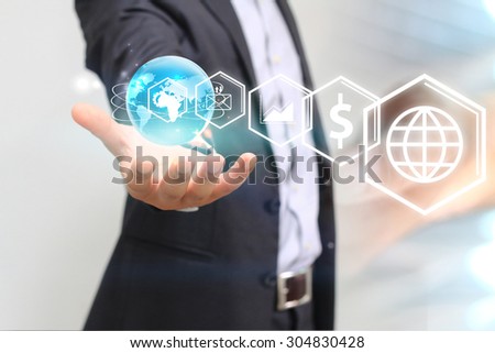 Businessman holding business icons.