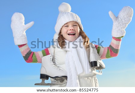 cute little girl in warm clothing outdoors with figure skates