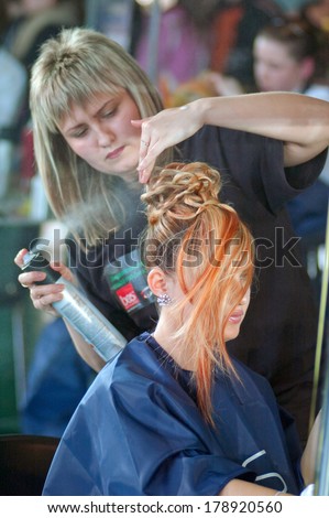 DNEPROPETROVSK, UKRAINE - MARCH 28, 2008: Stylist and his model prepare for the Championship on hairdressing, nail aesthetics and make YOUNG TALENTS OF UKRAINE