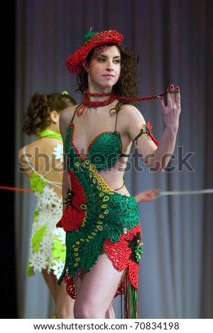 DNEPROPETROVSK, UKRAINE - MARCH 25: Ukrainian girl shows off his own clothes for unidentified young Ukrainian designer at FASHION TOWN  show on March 25, 2010 in Dnepropetrovsk, Ukraine