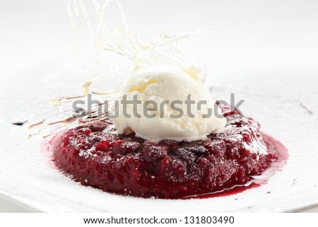 red frozen strawberries with white ice cream on white dish