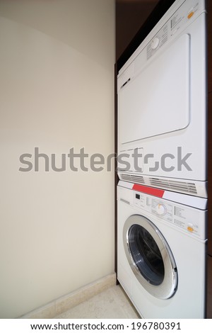 drying and washing machines in modern bright interior