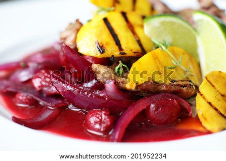 hot meat with potato and pink onion on white plate