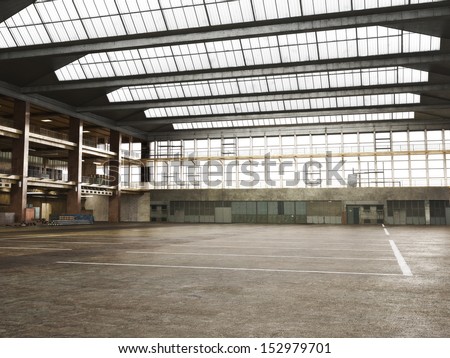 Large Interior grunge framed warehouse with an empty floor .