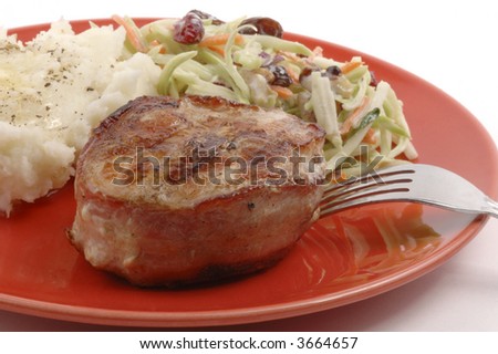 Grilled turkey filet wrapped in bacon with potatoes and coleslaw.