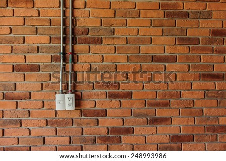 plug socket over the brick wall, texture background