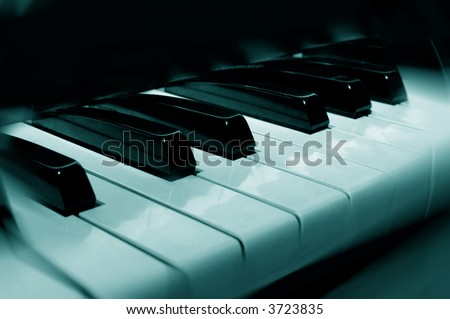 photo illustration of piano keys with blue tint