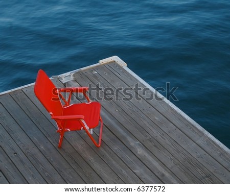 Red chair on dock, boston harbor massachusetts