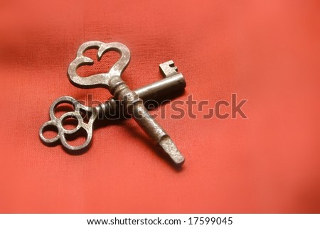 two vintage keys on red background