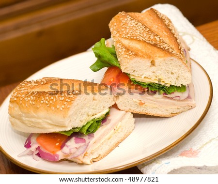 Deli Turkey and cheese sandwich with lettuce and onions
