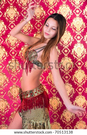 The young, graceful girl, dances in east suit