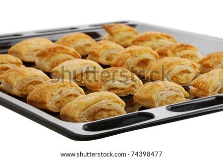 Black baking pan  with fresh baked bourekas aka burek - puff pastry filled with mashed potato