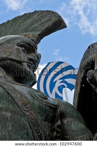 King Leonidas statue with Greek Flag in background.