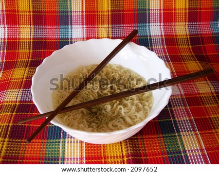 The welded noodles in a bowl with the Chinese sticks