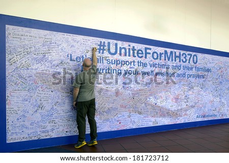 KUALA LUMPUR, MALAYSIA - MAR 15 2014 - MH370 missing plane, Malaysians showing support by writing prayers on a wall at a shopping complex.