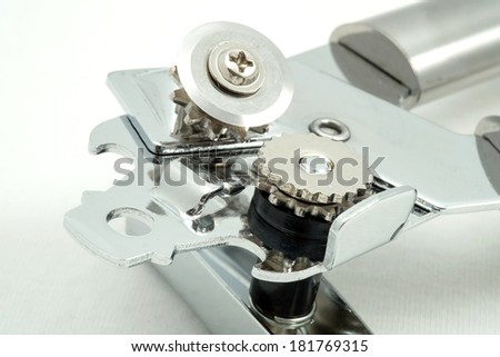 A close-up of a typical can opener on white background.