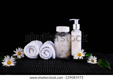 white daisy flowers and candle ,zen stone .massage oil on mat