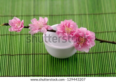 Spring branch Cherry blossoms in vase on mat