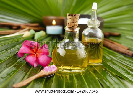 Spa set with frangipani,spa oil ,towel salt in bowl ,candle on palm leaf