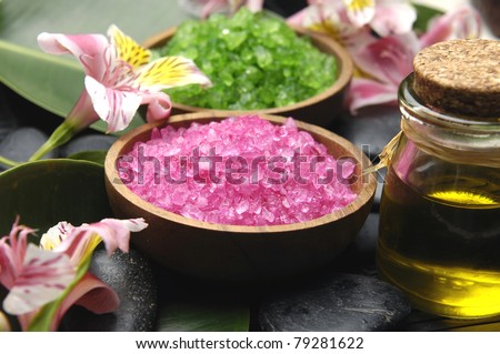 herbal salt in bowl with orchid with massage oil set for spa
