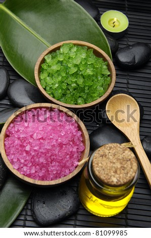 Green and red herbal salt with zen stone and leaf with massage oil set for spa