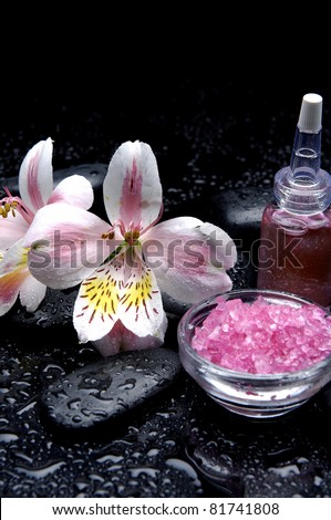 Still life with orchid and bowl of bath salt stones with massage oil