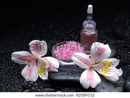 Still life with orchid and bath salt in bowl and stones with massage oil