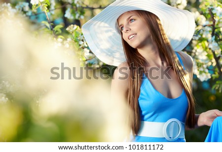 Woman wearing blue dress in amazing fruits garden