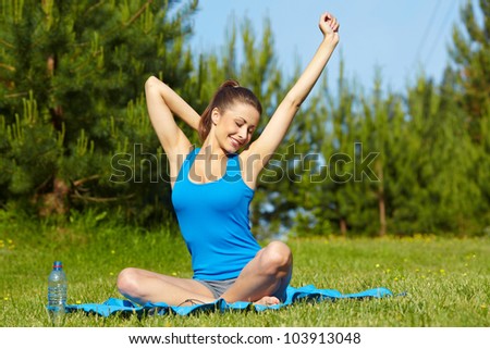 Beautiful happy smiling sport fitness model outside on summer / spring day.
