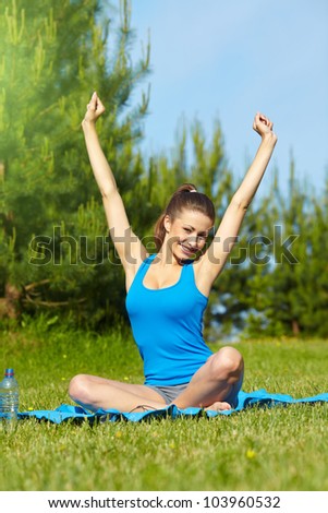 Beautiful happy smiling sport fitness model outside on summer / spring day.
