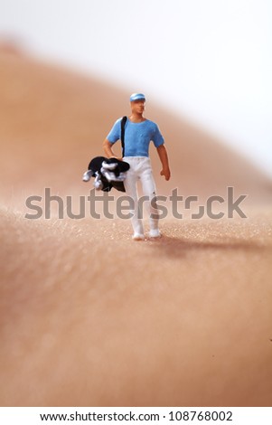 Miniature Figures playing golf on naked woman body