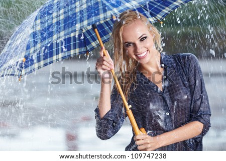 Beautiful sexy woman with blue  umbrella on rainy day