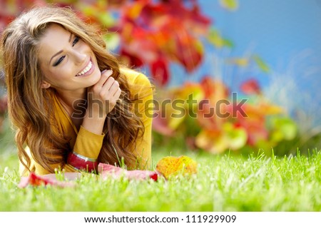 beautiful girl with book in the autumn park
