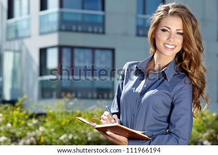 Beautiful business woman on the background of the modern office