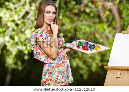 Woman artist paints nature