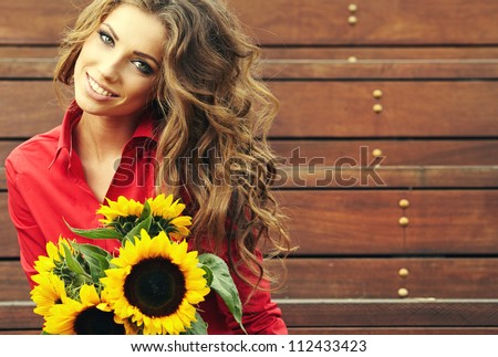 Fashion woman with sunflower at outdoor.