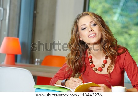 Beautiful young college student on a cafe.