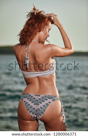 Bikini girl on the beach. Young beautiful woman in bikini on the beach on Adriatic Sea