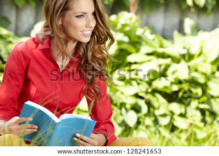 beautiful girl with book in the spring park