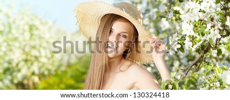 Spring woman in summer dress walking in park enjoying the sun.