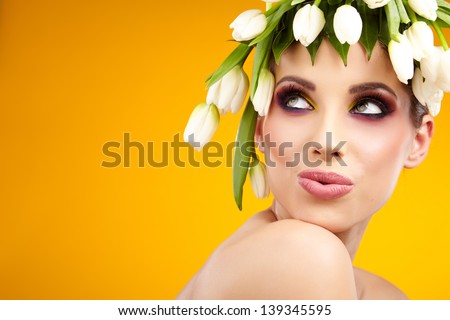 beauty woman portrait with wreath from flowers on head yellow  background