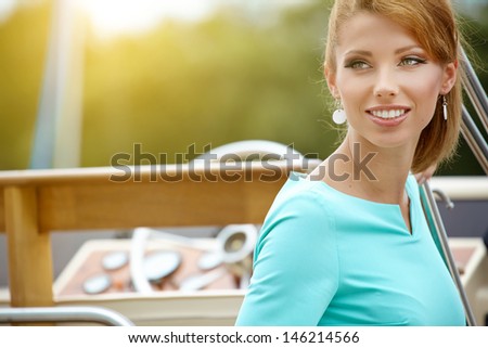 Elegant retro woman wear  dress , sitting near the wooden yacht. 60\'s inspiration