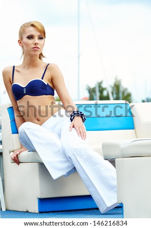 Fashion young woman standing in a port fashion style