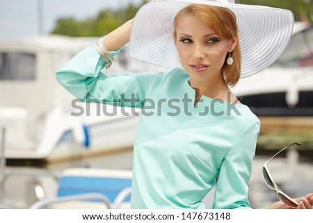 Beautiful young woman in hat summer outdoors