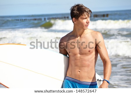surfer holding a surf board