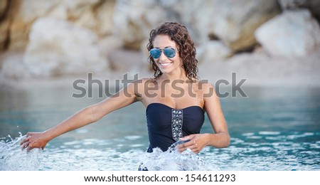 Beautiful sexy woman in bikini posing in water