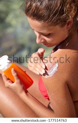 woman applying sun protection lotion